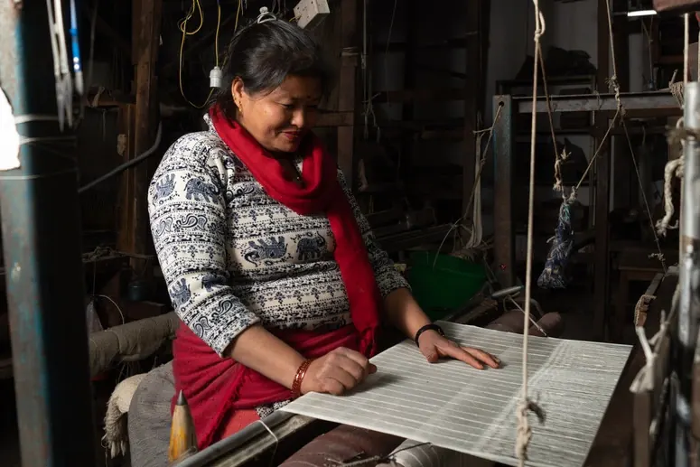 An artisan hand-making pashmina